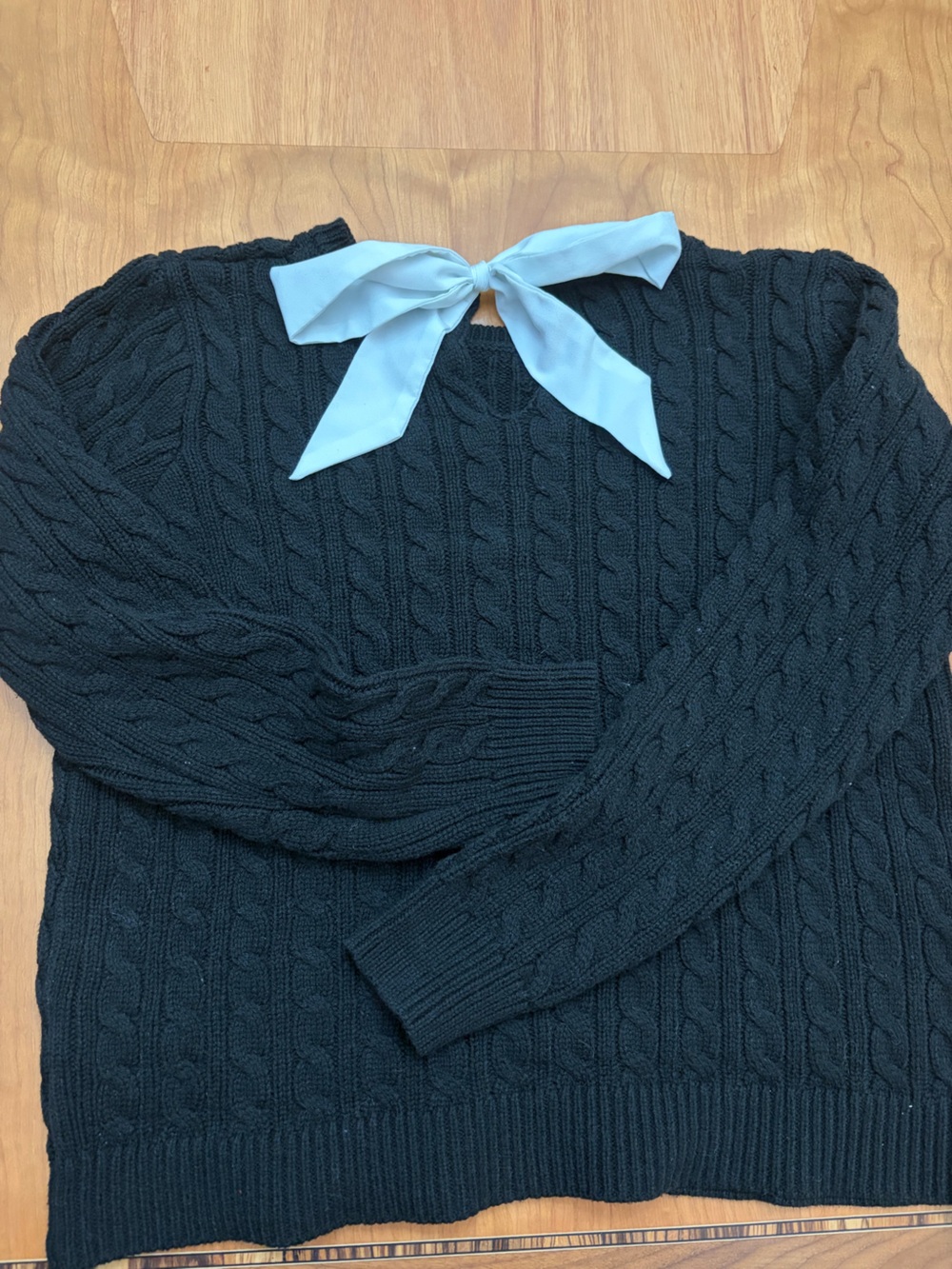 Ricki's Black Cable Knit Crewneck Sweater with white bow detail in back.